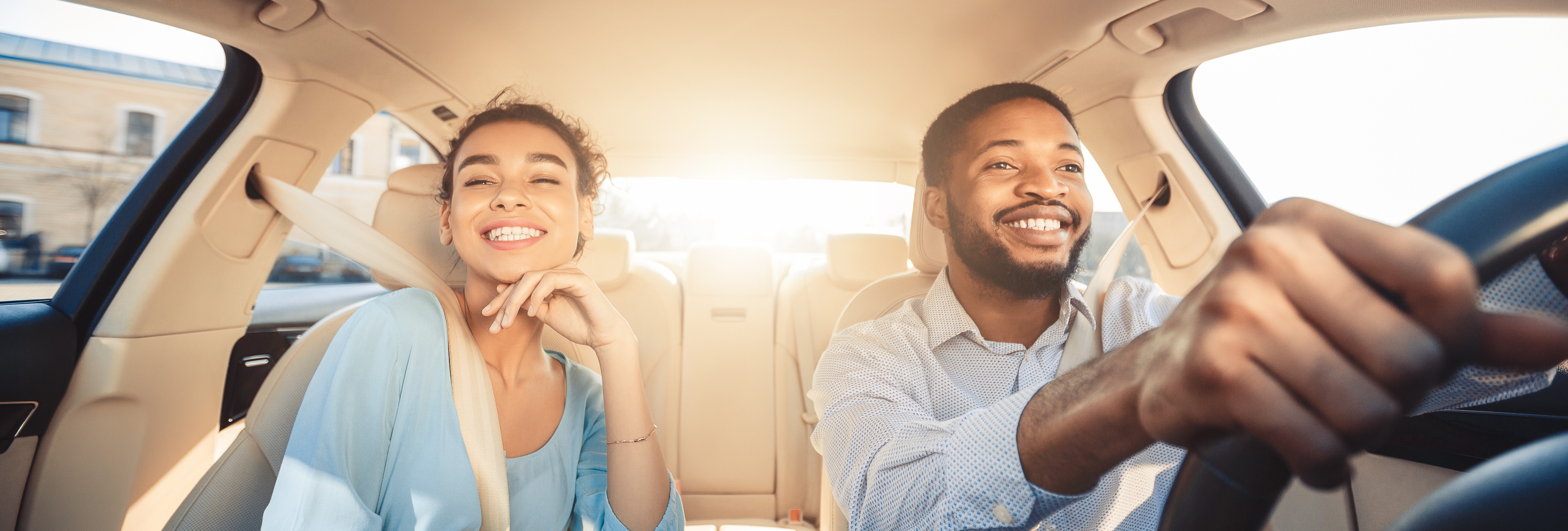 Couple driving in their new car