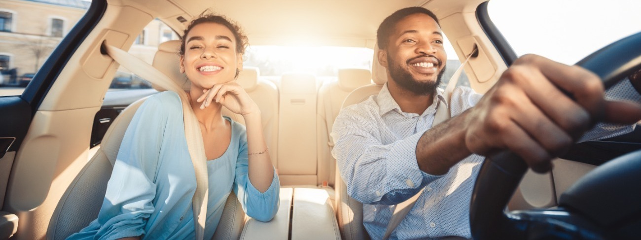 Couple driving in their new car